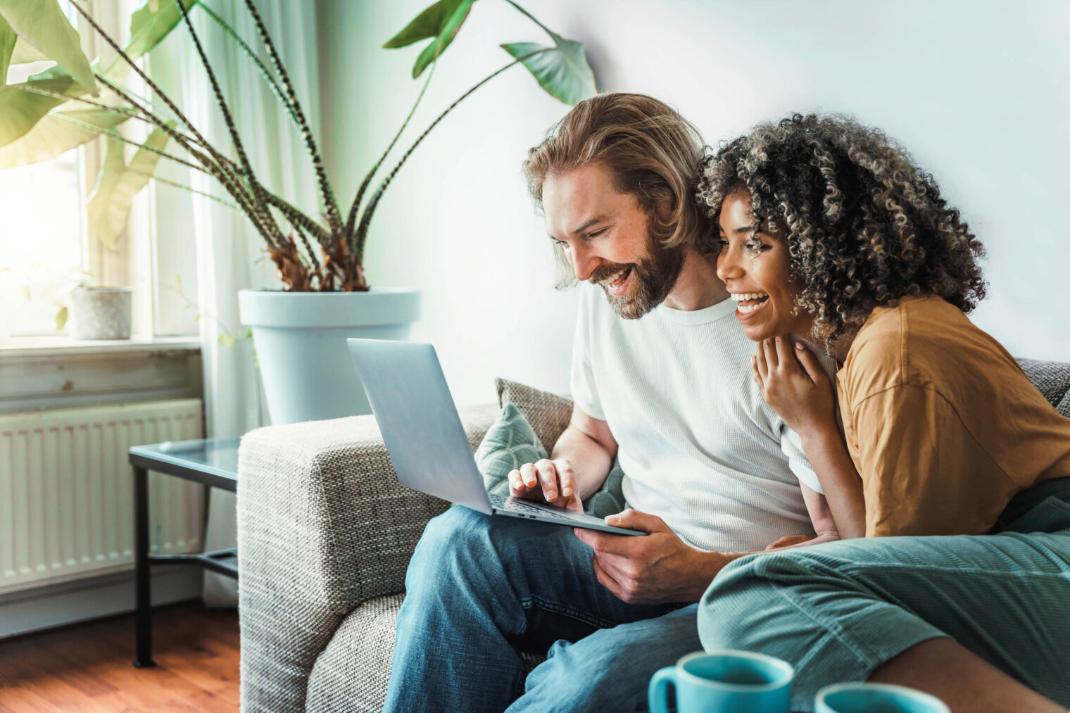 a couple on a laptop at ajax apartments omaha